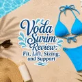Blue bikini flat lay by a swimming pool with sunglasses, sunscreen, a white towel, and decorative text reading Voda Swim Review: Fit, Lift, Sizing, and Support.