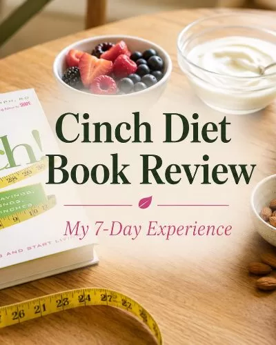 Cinch Diet Book Review featured image with the Cinch book, berries, yogurt, spinach, almonds, eggs, and a measuring tape on a warm wooden table.
