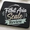 Black Fitbit Aria smart scale with centered decorative text that reads Fitbit Aria Scale Review.