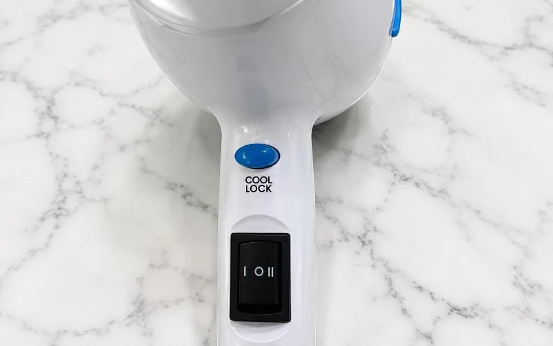 Close-up of the Solia hair dryer Cool Lock button and speed controls.