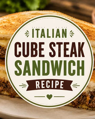 Italian cube steak sandwich with melted cheese on toasted bread featured on a rustic background with title graphic overlay