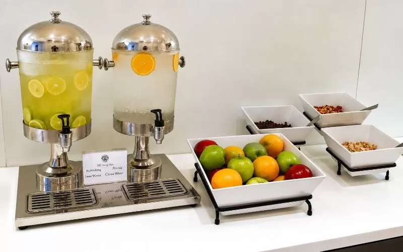 Spa refreshment station with citrus water, fresh fruit, and small snack bowls at Trump National Doral Miami.