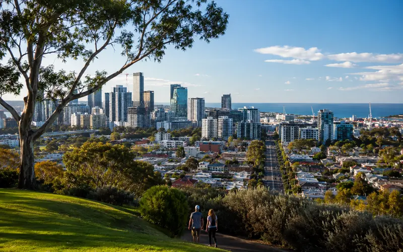 Australian coastal city surrounded by green parkland under a bright blue sky