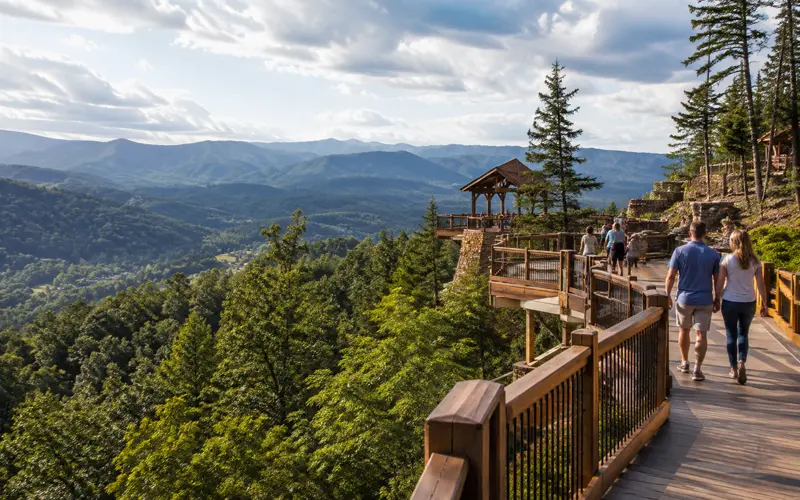 Visitors walking along a wooden mountain overlook with sweeping views of the Smoky Mountains near Gatlinburg.