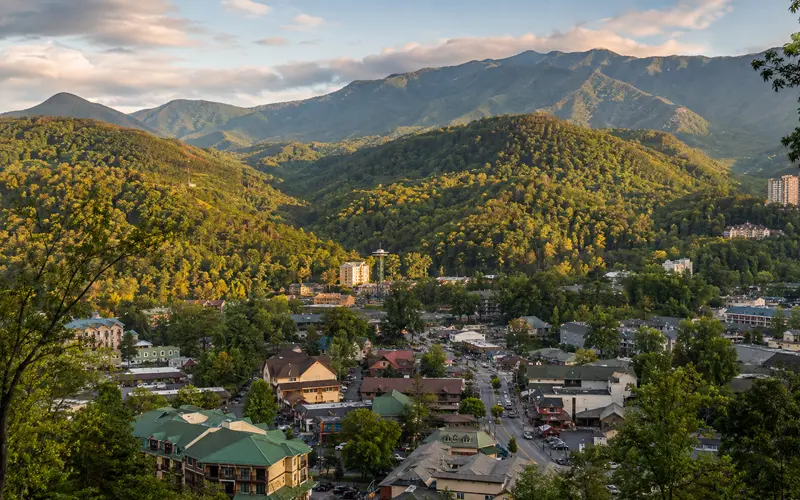 Elevated view of downtown Gatlinburg surrounded by the forested Great Smoky Mountains.
