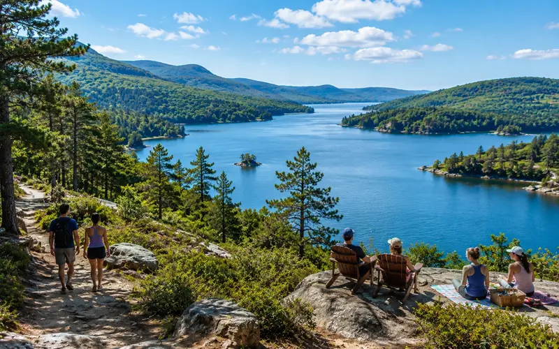 Travelers enjoying a scenic park with walking trails, water, overlooks, and natural landscapes.