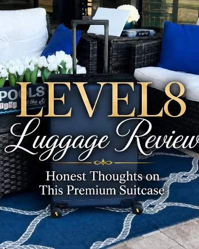 Navy LEVEL8 suitcase on a blue patio rug with decorative text that reads LEVEL8 Luggage Review Honest Thoughts on This Premium Suitcase.