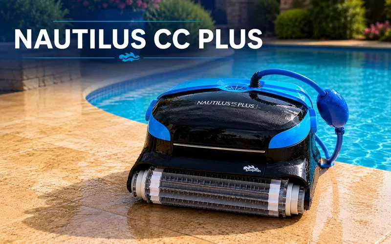 Dolphin Nautilus CC Plus robotic pool cleaner positioned beside a backyard swimming pool with tropical landscaping and clear blue water.