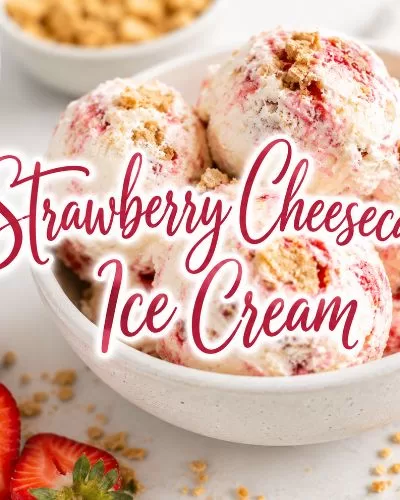Bowl of strawberry cheesecake ice cream with fresh strawberries, graham cracker pieces, and decorative text that reads Strawberry Cheesecake Ice Cream.