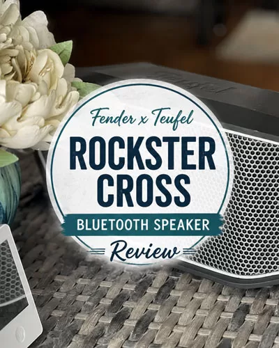 Fender x Teufel ROCKSTER CROSS speaker with a centered review title graphic on an outdoor table