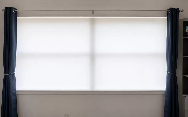 White covering stretched across a large window for a holiday projection setup