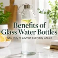 Glass water bottle with lemon and mint on a bright kitchen counter with title text about glass water bottles.