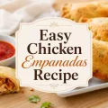 Easy Chicken Empanadas Recipe title graphic over golden chicken empanadas with red dipping sauce and chicken filling.