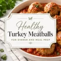 Turkey meatballs in marinara sauce with a centered title graphic for healthy turkey meatballs for dinner and meal prep.