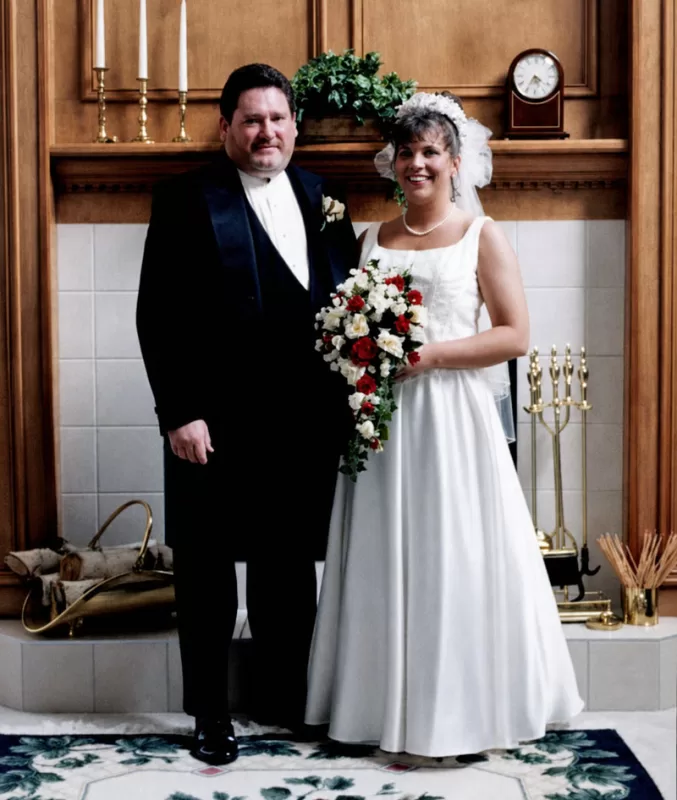 Colleen standing beside her father on her wedding day