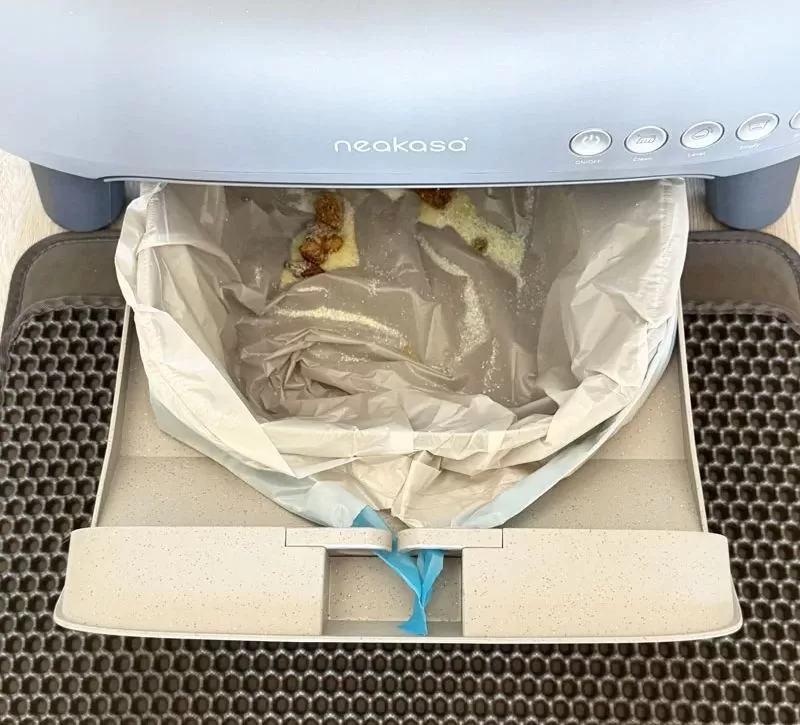 Neakasa M1 waste bin pulled out with trash bag and used litter inside