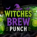 Halloween witches brew punch with glowing green soda, floating eyeball candies, lime slices, and spooky decorations featuring a centered witches brew punch graphic.