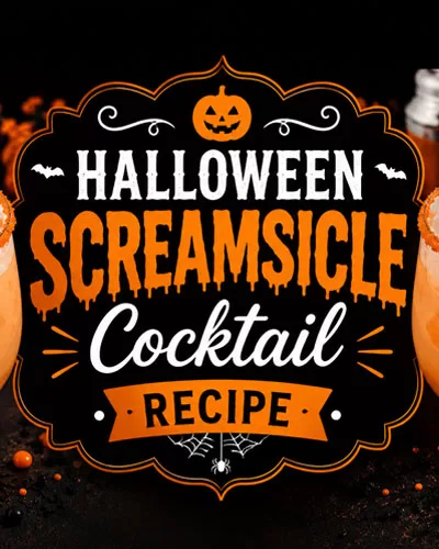 Halloween Screamsicle cocktail topped with whipped cream and black and orange sprinkles surrounded by pumpkins, spooky decor, and glowing candlelight.