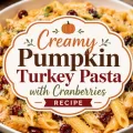 Creamy pumpkin turkey pasta with dried cranberries and parmesan cheese featured in a decorative autumn-themed recipe graphic.