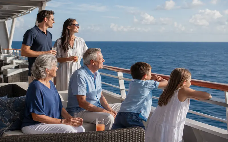 Multigenerational family enjoying time together on the deck of a luxury cruise ship.