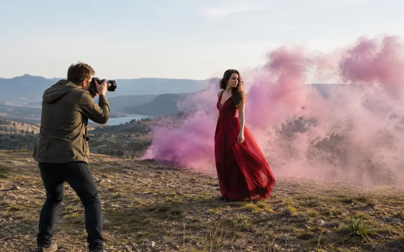 Colored smoke drifting across an open outdoor setting during a planned photography session.